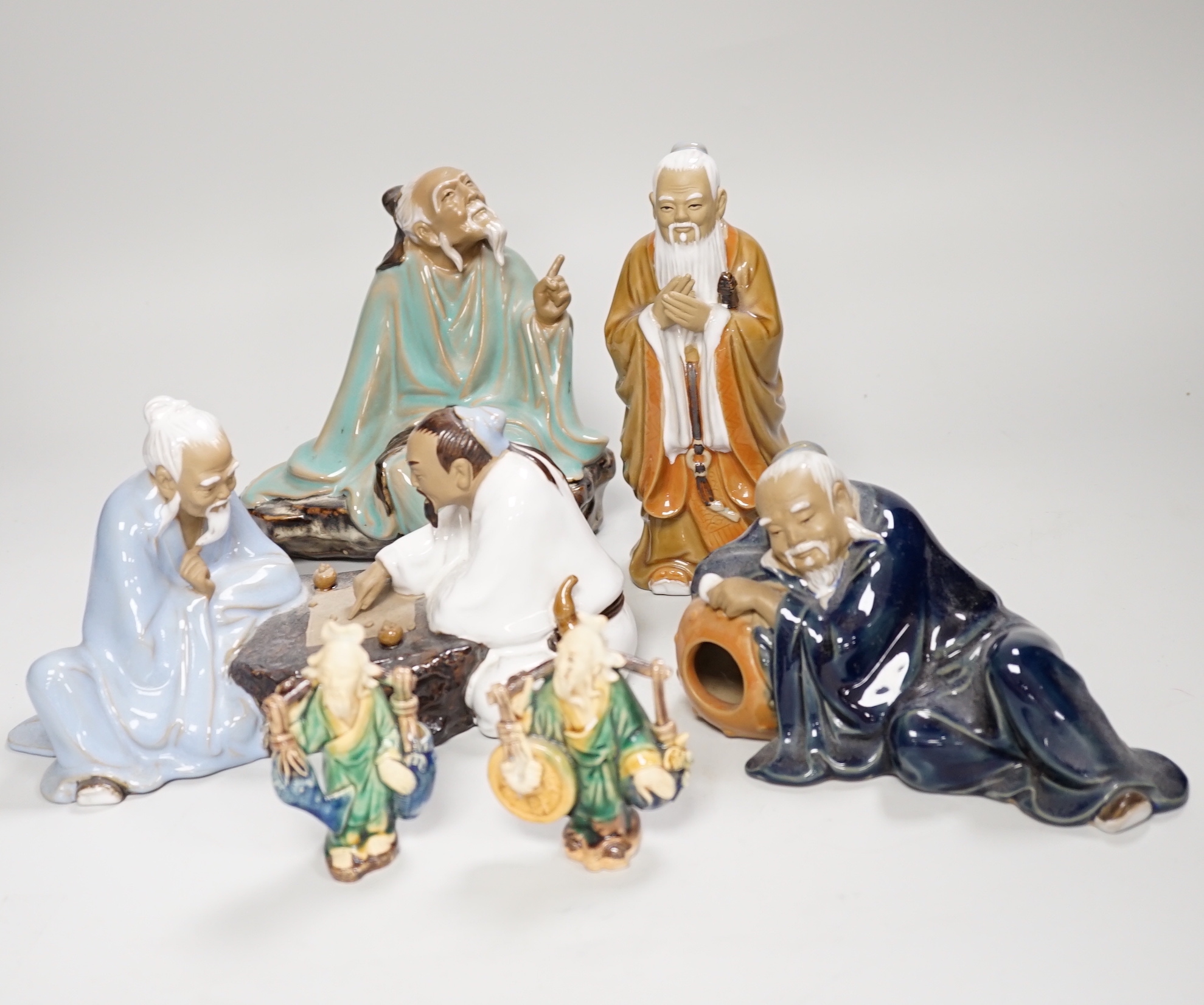 Thirteen Shiwan pottery figure groups of tigers and figures, the largest 25cm high